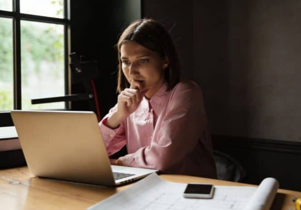 Person working at a desk with laptop.