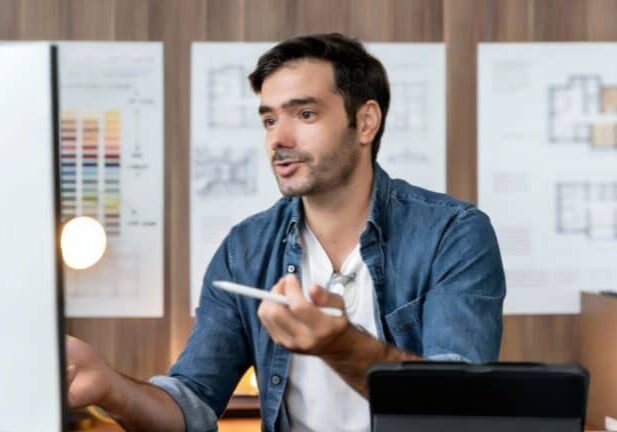 Person working at a desk with plans.